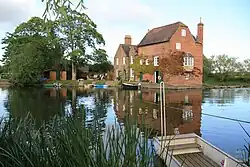Cropthorne Mill in the distance across the river Avon and rope ferry in the foreground seen from Fladbury