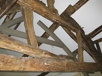 End bay to barn with new metal support to cruck frame