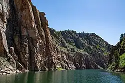 River below a steep rocky cliff