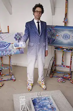 Dadara in his studio with works from the Exchanghibition Bank project, 2011.