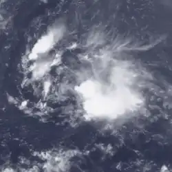 A weak and disorganized tropical storm with amorphous convection and a visible center of circulation