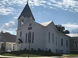 Old plain white church with tower