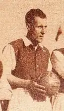 A black and white photo of a man holding a football