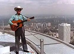 1980 colour photograph of Donn Reynolds performing outside atop the main deck roof of the CN Tower (Toronto, Ontario, Canada).