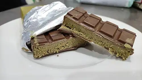 A bar of Dubai chocolate, filled with knafeh and ground pistachios