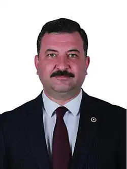 Portrait photograph of Ekrem Gökay Yüksel in a suit