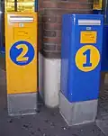 Post boxes in Heinola, Finland. Yellow 2nd class postbox is very common, blue 1st class mailboxes only at selected places.