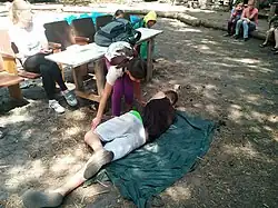 "Trukhanivska Sich - VHF - Kolo.media." camp kids are learning the principles of first aid. Providing recovery position.