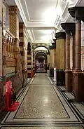 First-floor corridor, with faience tiled walls and terrazzo floor with mosaic border contrasted with the simple white plaster-work ceiling, Victoria Building, University of Liverpool