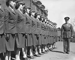 A group of women officer candidates brought to attention by a male instructor during the Second World War