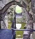 Looking down into the basement of the isolated keep. Part of the vaulted passageway can be seen in the far stairwell.
