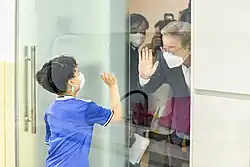 Lee Jae Myung visiting a child care center and waving at a child