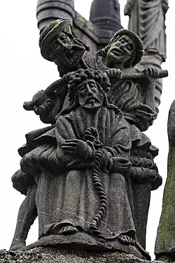 Two soldiers use a bar to press the crown of thorns into Jesus' head.