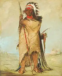 Hó-ra-tó-a, a Crow warrior with headdress, bison robe, and hair reaching the ground. Painted by George Catlin, Fort Union 1832.