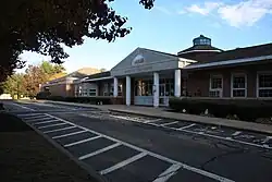 The front building facade of Harry Lee Cole School. The building is a red brick building.