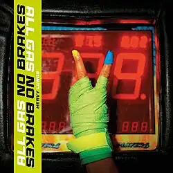 A photo of a green-gloved hand making a V sign in front of a digital clock.