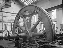 Rolling mill flywheel.[80] The wheel is rotated by the pinion on the right.