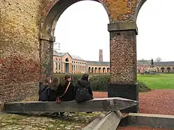 View of the oval courtyard and the statue of H. de Gorge, who early in the 19th century built the mining complex of Grand Hornu, which is an example of functional town-planning and evidence of the importance of the Industrial Revolution in Wallonia.