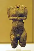 Female torso in darker stone with a hole in the throat and dírkama thighs, Plastiras type (EC I, 2800–2700 BCE; Museum of Prehistoric Thera)