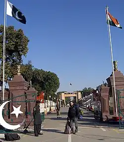 A tourist in front of the Wagah border post, on the Pakistani side, looking towards Attari on the Indian side.