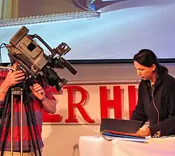 Irma Boom demonstrating a book to a camera operator