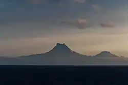 Isanotski (8,104&nbsp;ft; 2,470&nbsp;m) and Roundtop (6,128&nbsp;ft; 1,868&nbsp;m) volcanoes as seen from the Unimak Pass in the morning light.