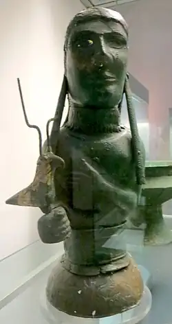 Bronze bust of a goddess holding a bird from the tomb that was originally thought to represent the goddess Isis