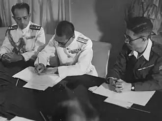 A Japanese Navy officer signing the surrender of Penang aboard HMS Nelson on 2 September 1945. Penang was liberated by the Royal Marines on the following day under Operation Jurist.