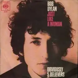 Single cover of "Just Like a Woman", a headshot of Bob Dylan looking into the camera