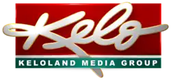In a red box, a white thick script with the letters K E L O (the E L and O in lowercase), inside and extending beyond a red box. Beneath is a green box with the label "KELOLAND MEDIA GROUP".
