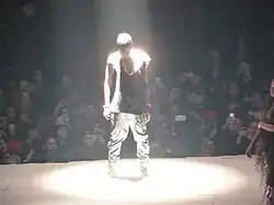 West wears his mirror mask that reflects his light beam.