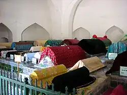 Tombs are decorated with blue glazed tiles and draped in colorful silks.
