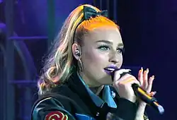 Portrait of a young, pale-skinned female with blond hair.