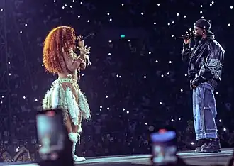 Lamar and SZA standing in front of each other as they perform the song