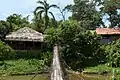 Wood suspension bridge passing through the Moyog River behind the heritage village