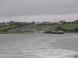 a view of a river-crossing ferry port from the opposite bank