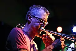 A member of the band playing trombone