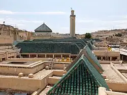 Rooftop view of the Kissaria in 2023, after recent renovations, with sloped wooden roofs covered in green tiles