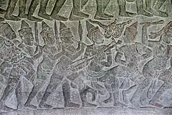 Angkor Wat, 16th century AD, showing a musician playing a kse diev.[13]