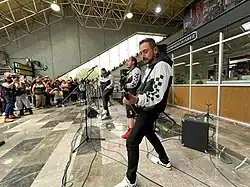 A band plays in front of an audience.