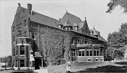 A picture of Lathrop Hall, covered in ivy, around 1905, prior to its usage by the Department of Music and subsequent demolition in the 1960s
