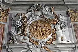 Stuccoed gilt medallion depicting Apollo and Marsyas