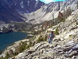 Hikers leaving Quiet Lake, which sits at the base of Castle Peak and Merriam Peak.