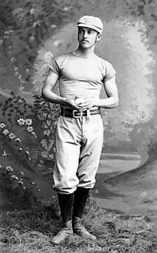 Richmond standing, holding a baseball