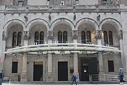 The hotel's main entrance, a set of five arches, with a metal-and-glass canopy above them