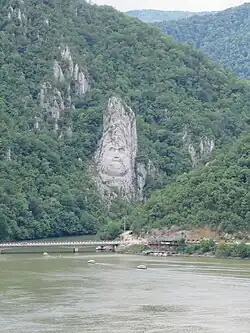 The rock sculpture of Decebalus (2004) at the Iron Gates on Danube: overview…