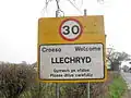 Bilingual English-Welsh sign with speed limit, Llechryd