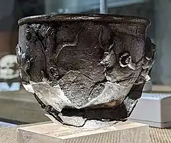 A tree (perhaps with mistletoe) and a deer.