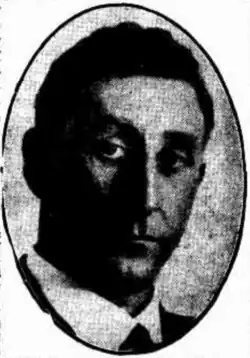 A grainy black and white photograph portrait of M. M. Flannery M.L.A enclosed within a vertical oval border.