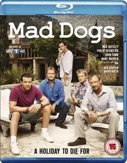 A BD cover with the title "Mad Dogs" at the top. Underneath are five middle aged males, four are sitting while the fifth in the middle is standing and on the telephone. Behind them is a villa.